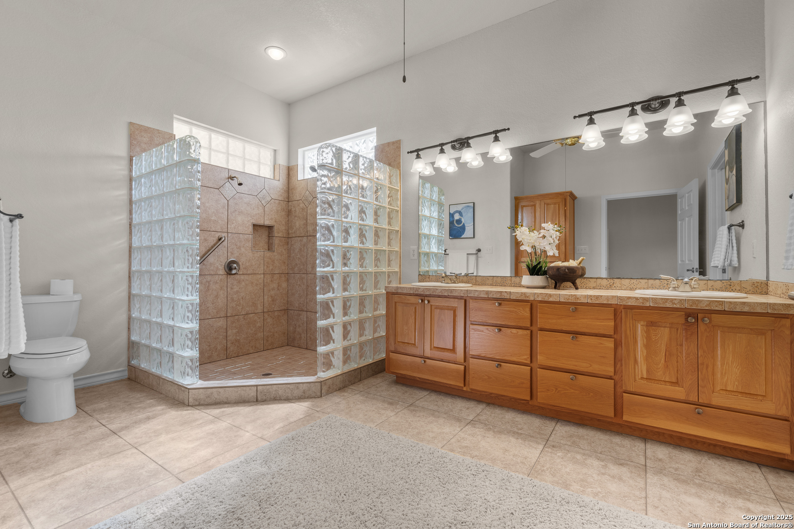 174 Edgewood Circle Bandera, TX 78003 - Photo 26 of 33 a bathroom with a double vanity sink mirror and toilet