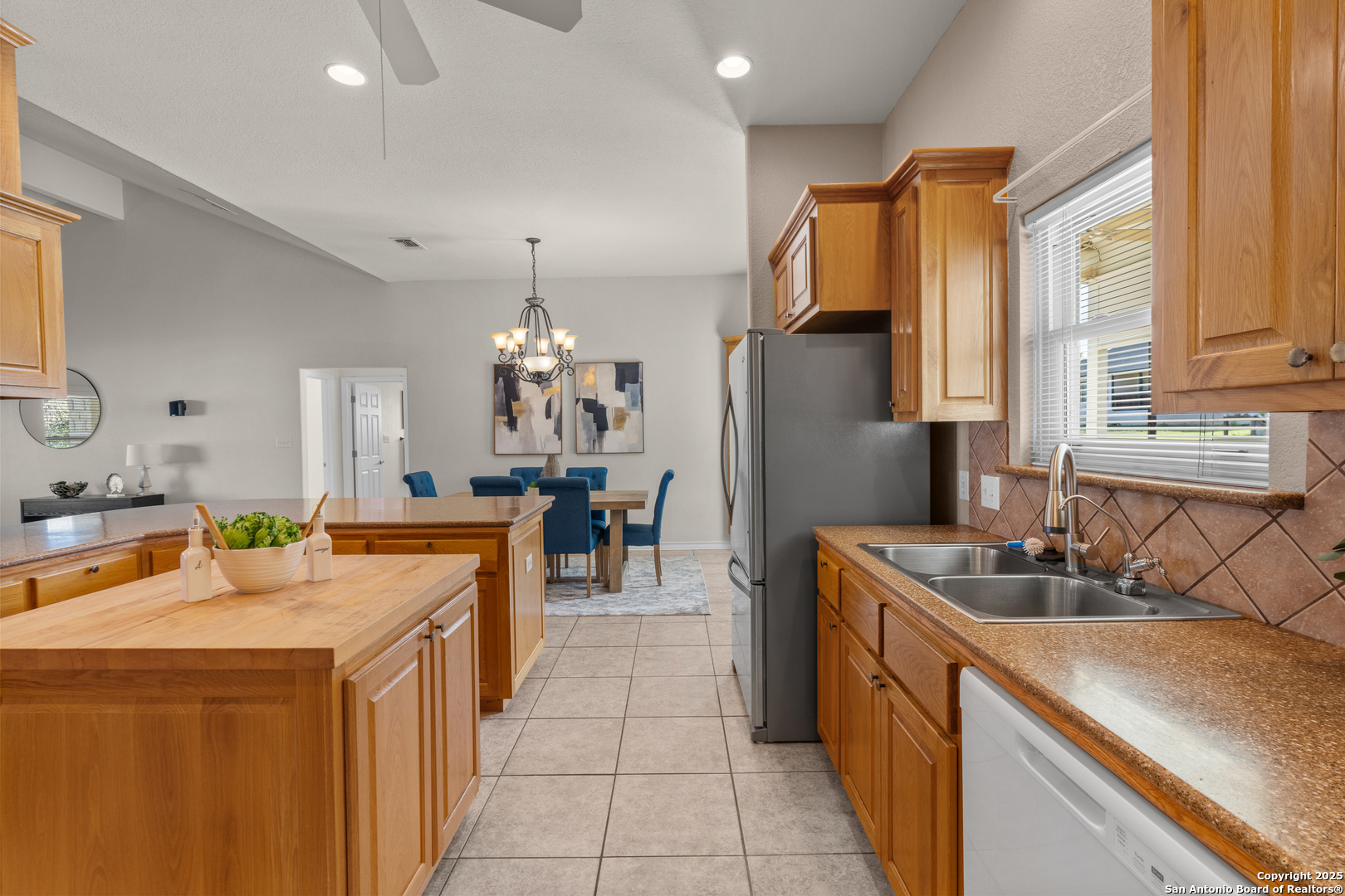 174 Edgewood Circle Bandera, TX 78003 - Photo 6 of 33 a kitchen with stainless steel appliances granite countertop a sink a stove and a refrigerator