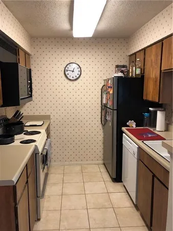 a kitchen with a sink a stove and a microwave