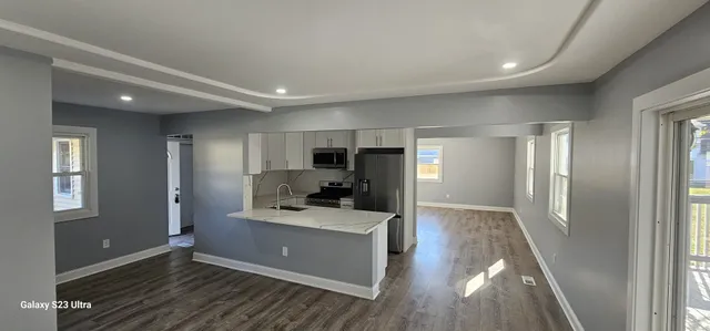 a view of a kitchen cabinets wooden floor and a window