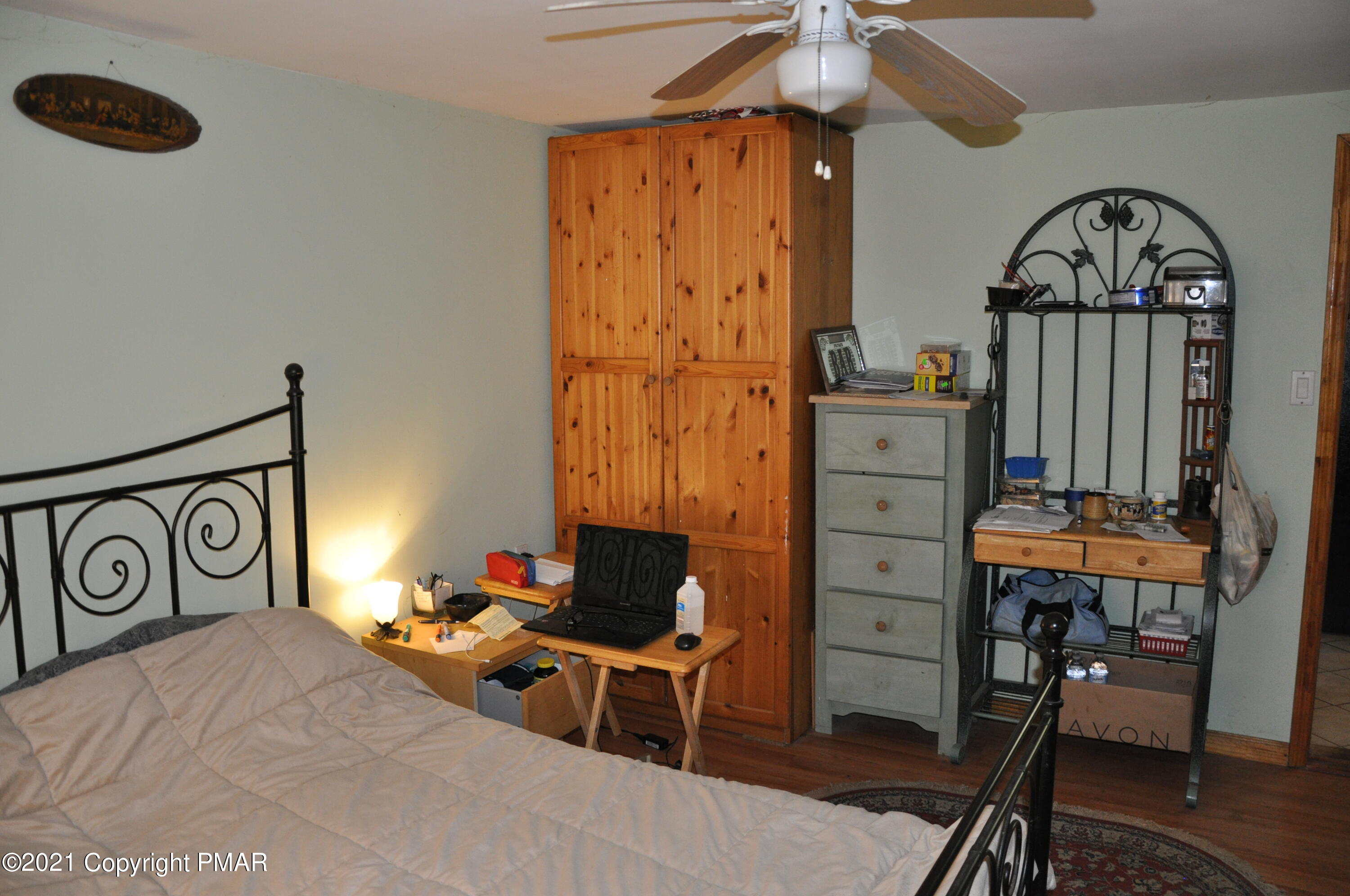 1407 Astolat Road Effort, PA 18330 - Photo 8 of 16 a bedroom with a bed a desk and chair with the bookshelf