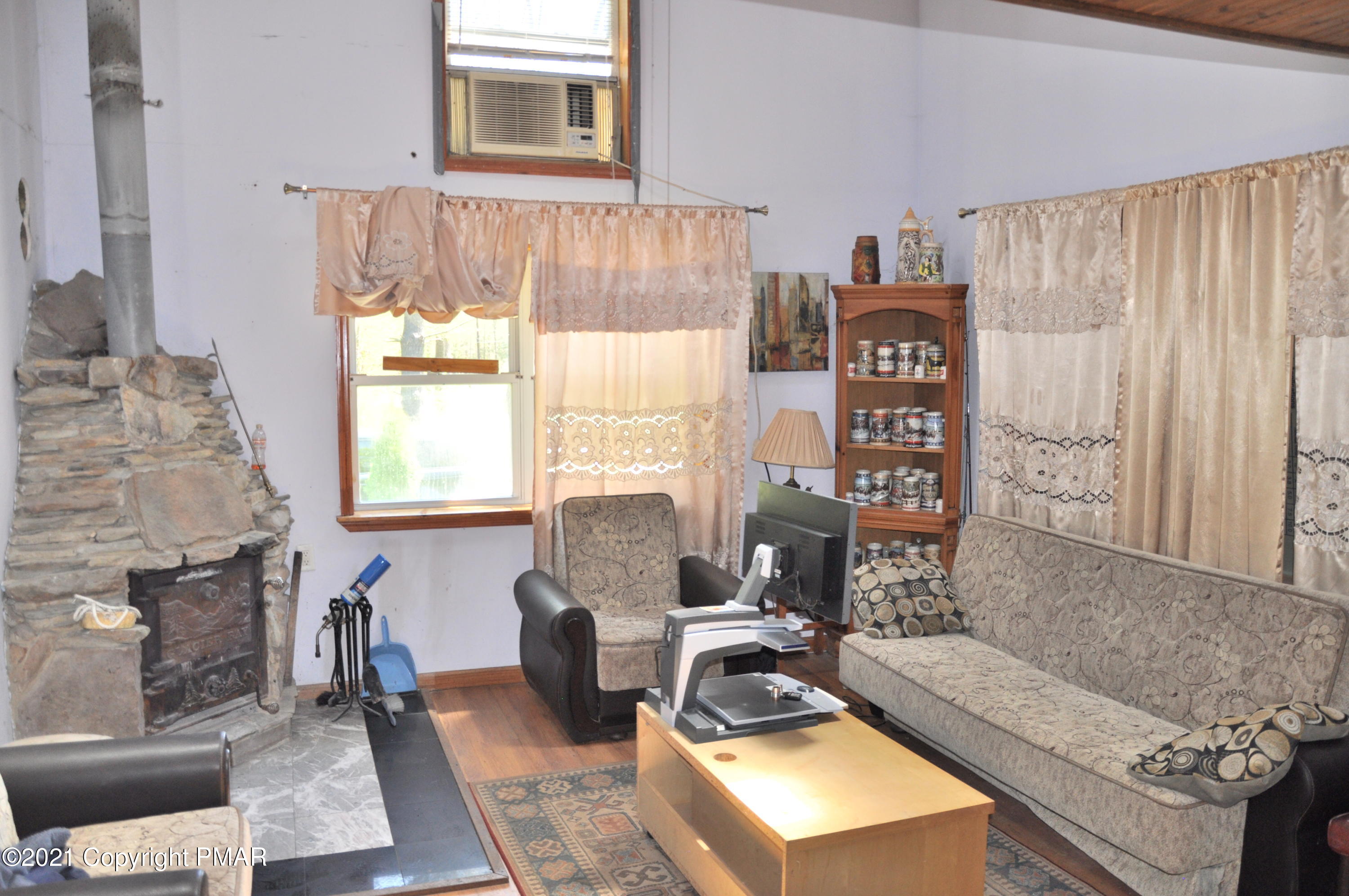 1407 Astolat Road Effort, PA 18330 - Photo 10 of 16 a living room with furniture a window and a fireplace