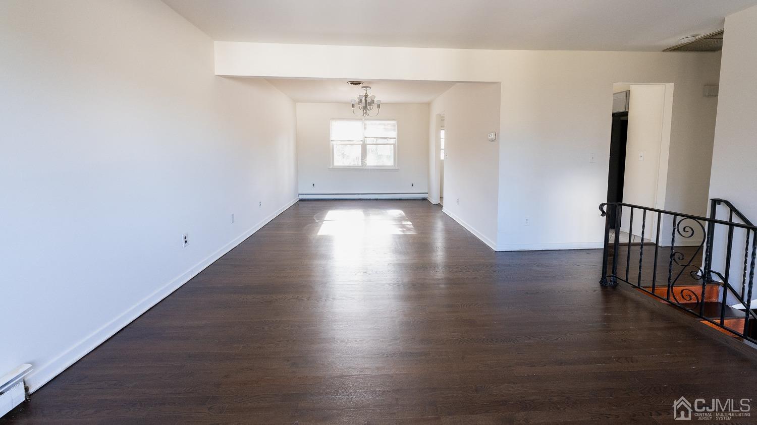 103 Alfred Street Edison, NJ 08820 - Photo 10 of 21 an empty room with wooden floor and windows