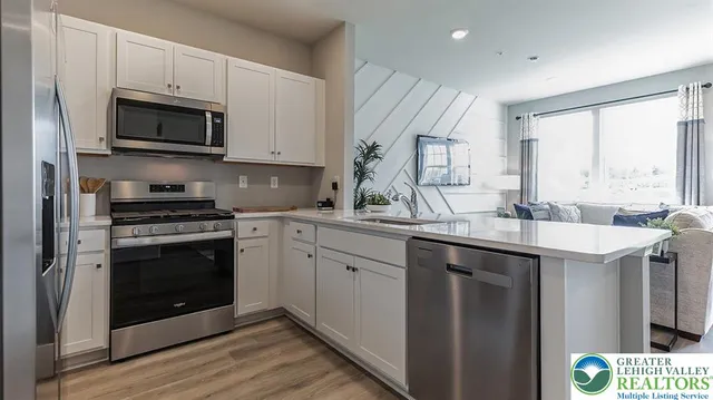 a kitchen with a sink stove and microwave