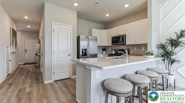 a kitchen with stainless steel appliances a sink and a refrigerator