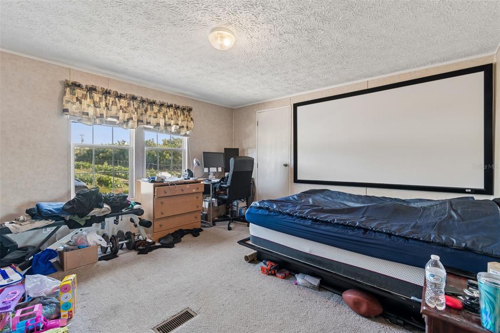 11101 Sumner Road Wimauma, FL 33598 - Photo 13 of 35 a bedroom with furniture and a large window