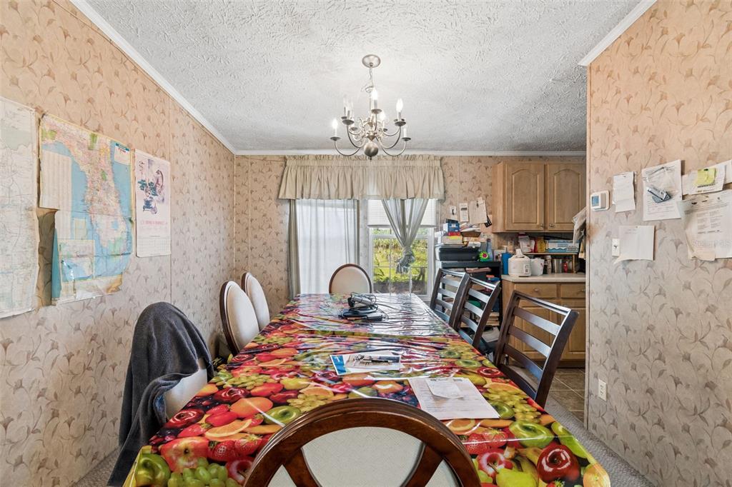 11101 Sumner Road Wimauma, FL 33598 - Photo 6 of 35 a bedroom with furniture and a chandelier