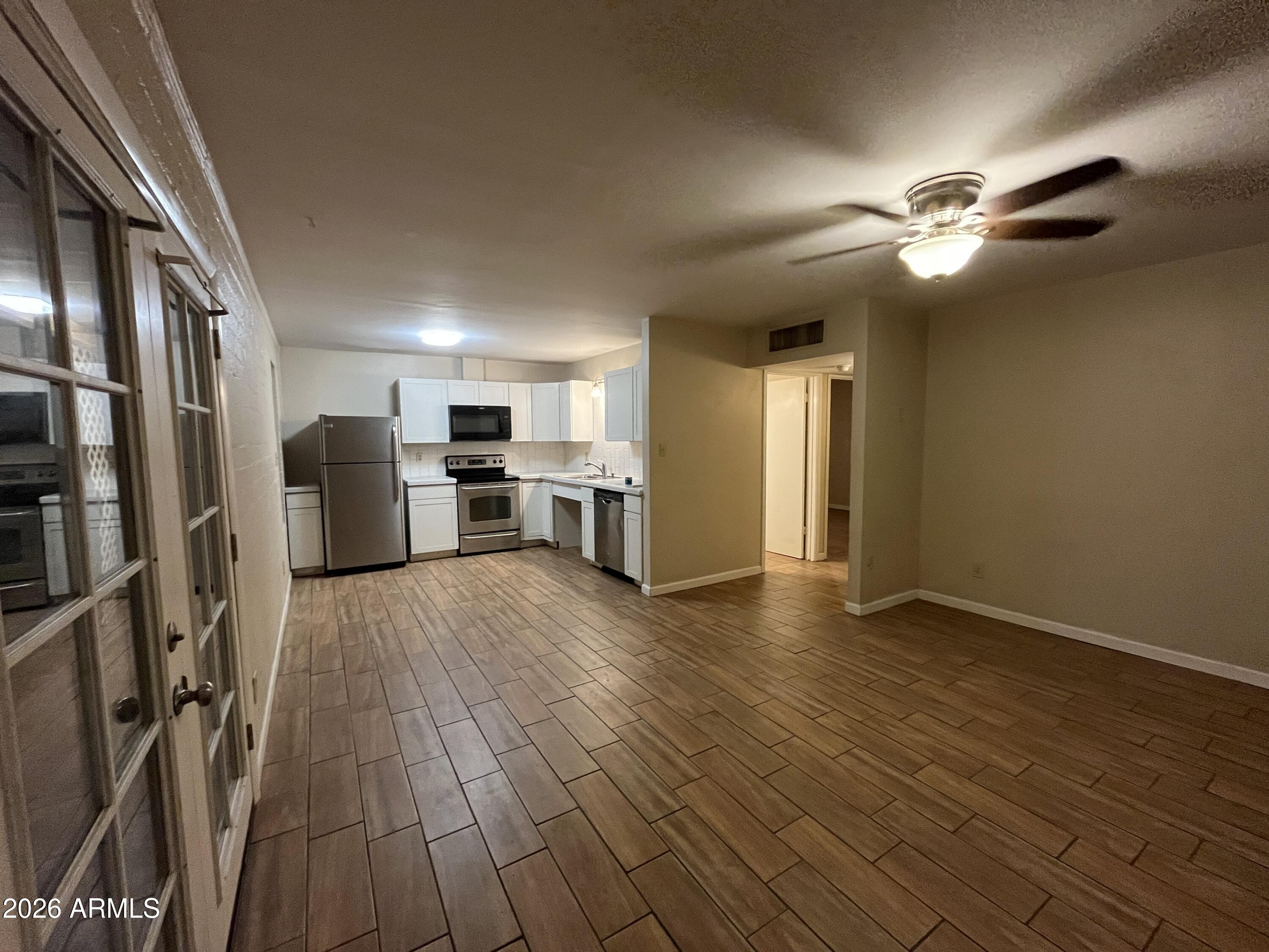 521 West 10th Street, Unit 4 Tempe, AZ 85281 - Photo 2 of 11 a view of empty room with wooden floor and ceiling fan