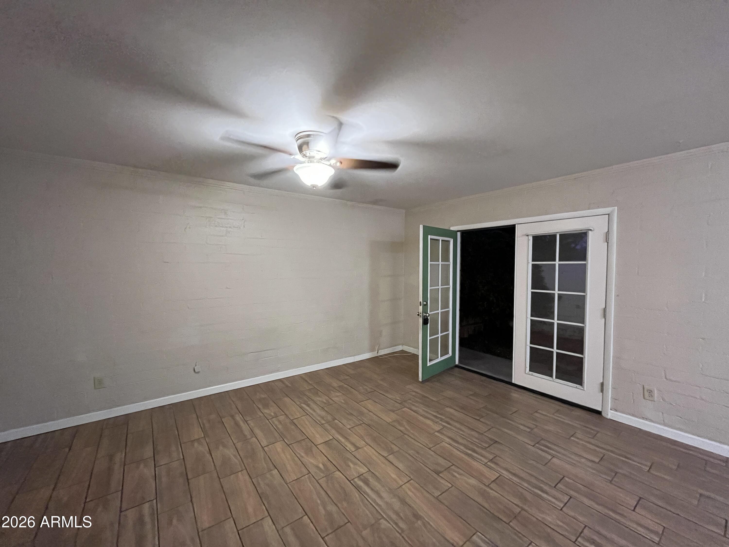 521 West 10th Street, Unit 4 Tempe, AZ 85281 - Photo 6 of 11 an empty room with wooden floor and window
