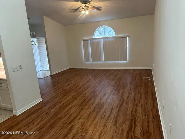 wooden floor in an empty room with a window