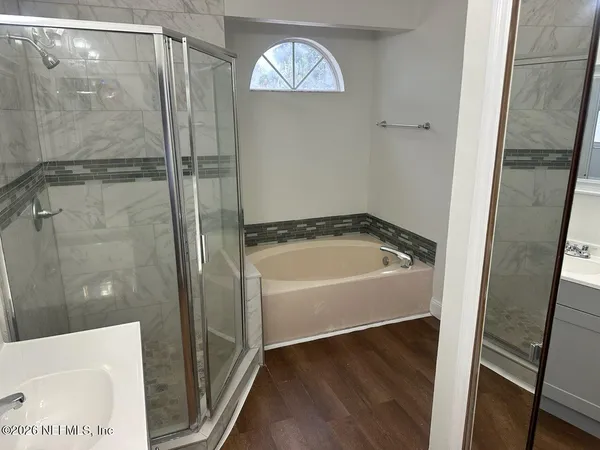 a bathroom with a bathtub and a shower