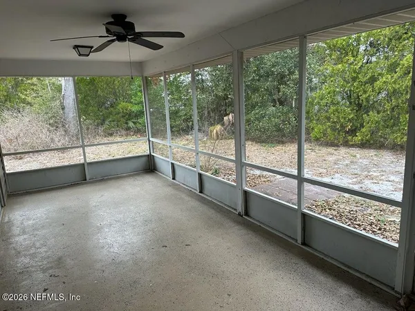a view of an empty room with a large window with outer view