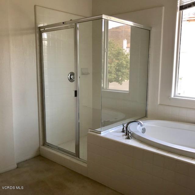 1511 Hidden Ranch Drive Simi Valley, CA 93063 - Photo 13 of 27 a bathroom with a bathtub and a shower