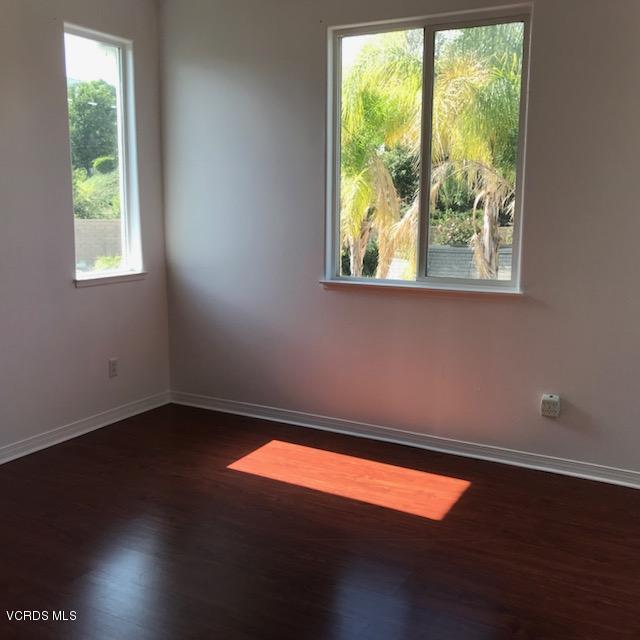 1511 Hidden Ranch Drive Simi Valley, CA 93063 - Photo 17 of 27 an empty room with wooden floor and windows