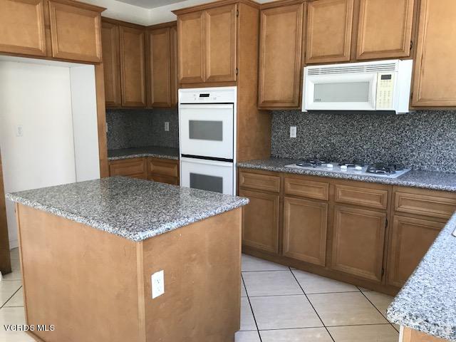 1511 Hidden Ranch Drive Simi Valley, CA 93063 - Photo 5 of 27 a kitchen with granite countertop a sink a stove and cabinets