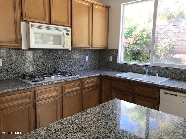 1511 Hidden Ranch Drive Simi Valley, CA 93063 - Photo 6 of 27 a kitchen with stainless steel appliances kitchen island granite countertop a sink stove and cabinets