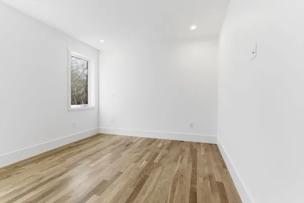 a view of room with wooden floor and fan