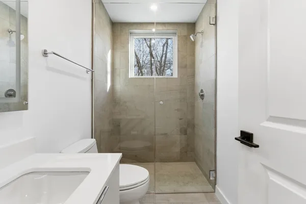 a bathroom with a toilet a sink and a shower