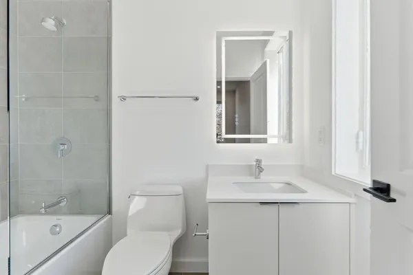 a bathroom with a sink toilet and shower