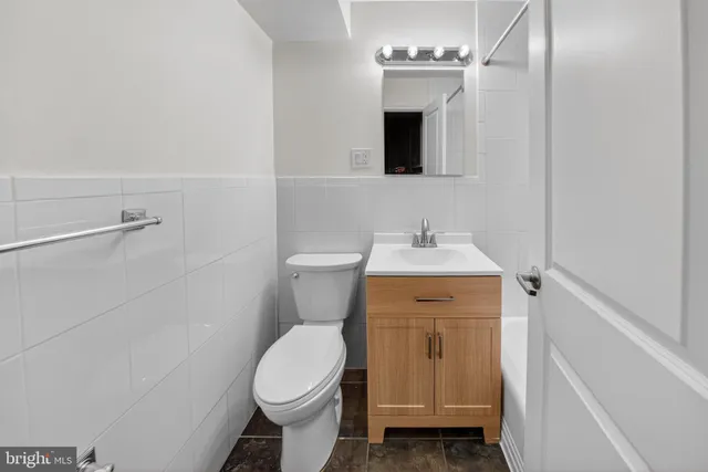 a bathroom with a toilet sink and mirror