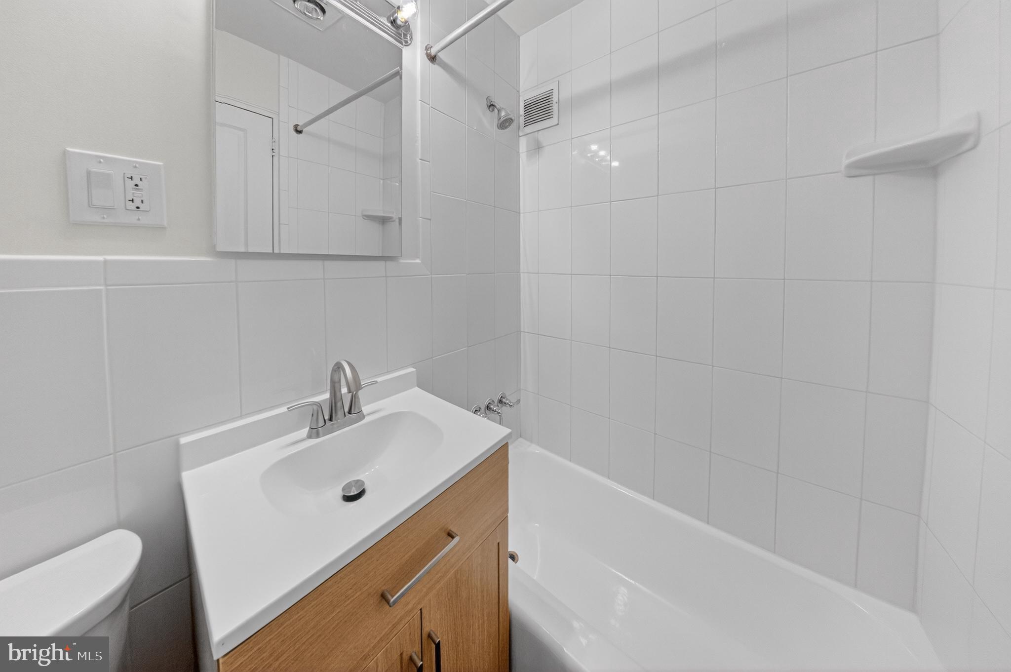 4840 MacArthur Boulevard Northwest, Unit 401 Washington, DC 20007 - Photo 17 of 18 a bathroom with a sink a toilet and shower