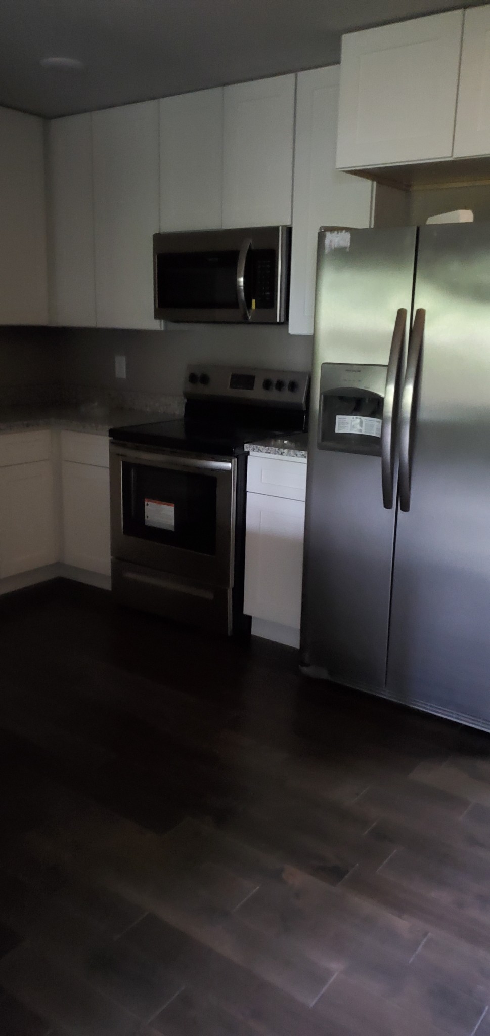 678 Hog Back Ridge Road Bethpage, TN 37022 - Photo 6 of 9 a kitchen with granite countertop white cabinets and stainless steel appliances