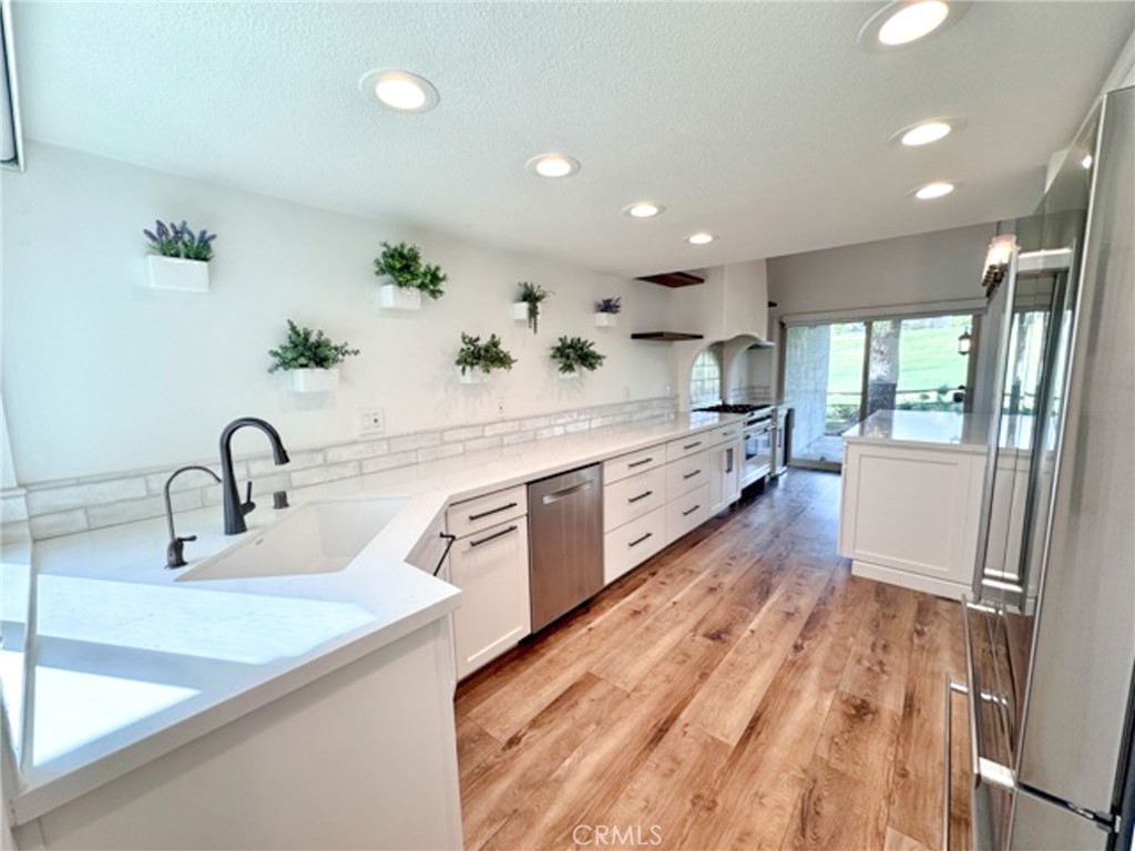 38901 Pso Corta Murrieta, CA 92563 - Photo 12 of 51 a large kitchen with kitchen island a sink stainless steel appliances and cabinets