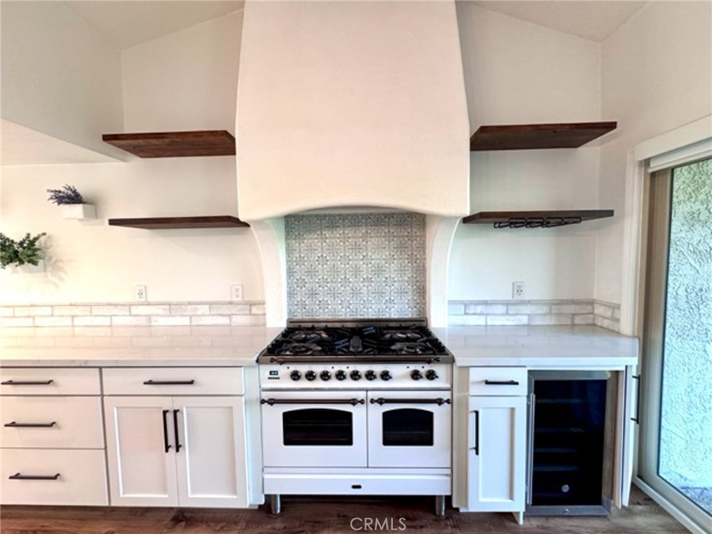 38901 Pso Corta Murrieta, CA 92563 - Photo 15 of 51 a kitchen with granite countertop a stove and a white cabinet