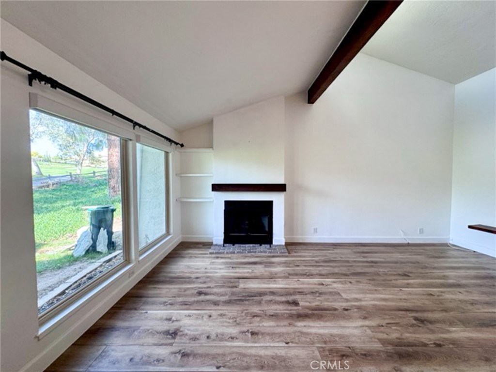 38901 Pso Corta Murrieta, CA 92563 - Photo 21 of 51 a view of empty room with wooden floor and a fireplace