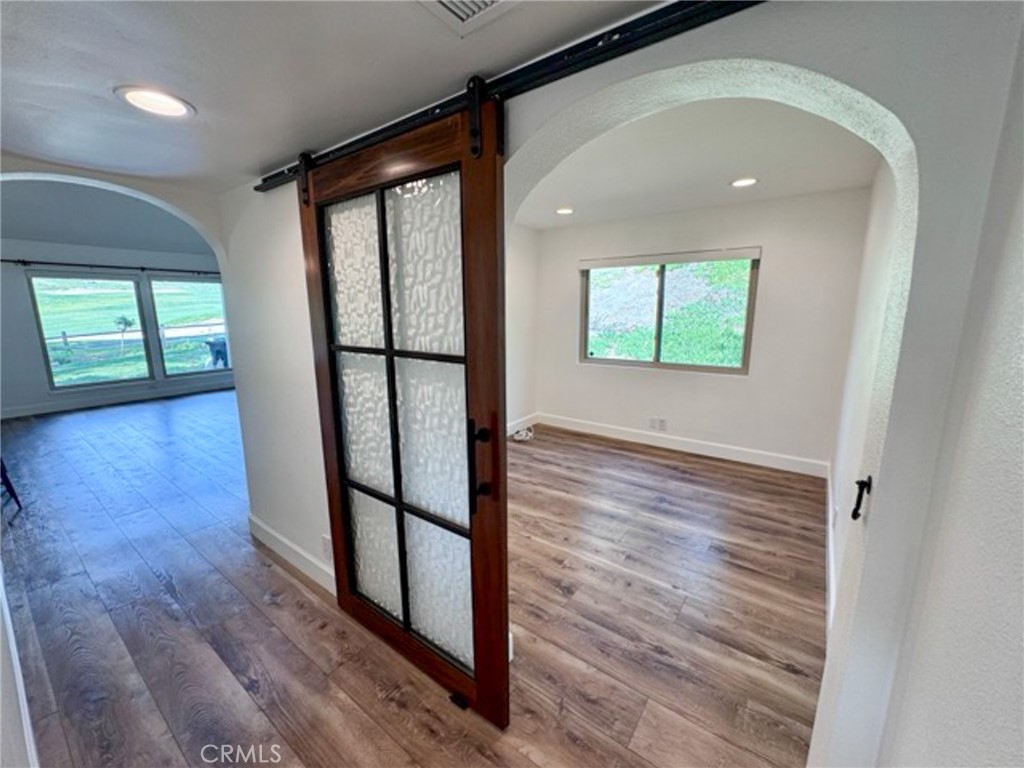38901 Pso Corta Murrieta, CA 92563 - Photo 24 of 51 an empty room with wooden floor and windows