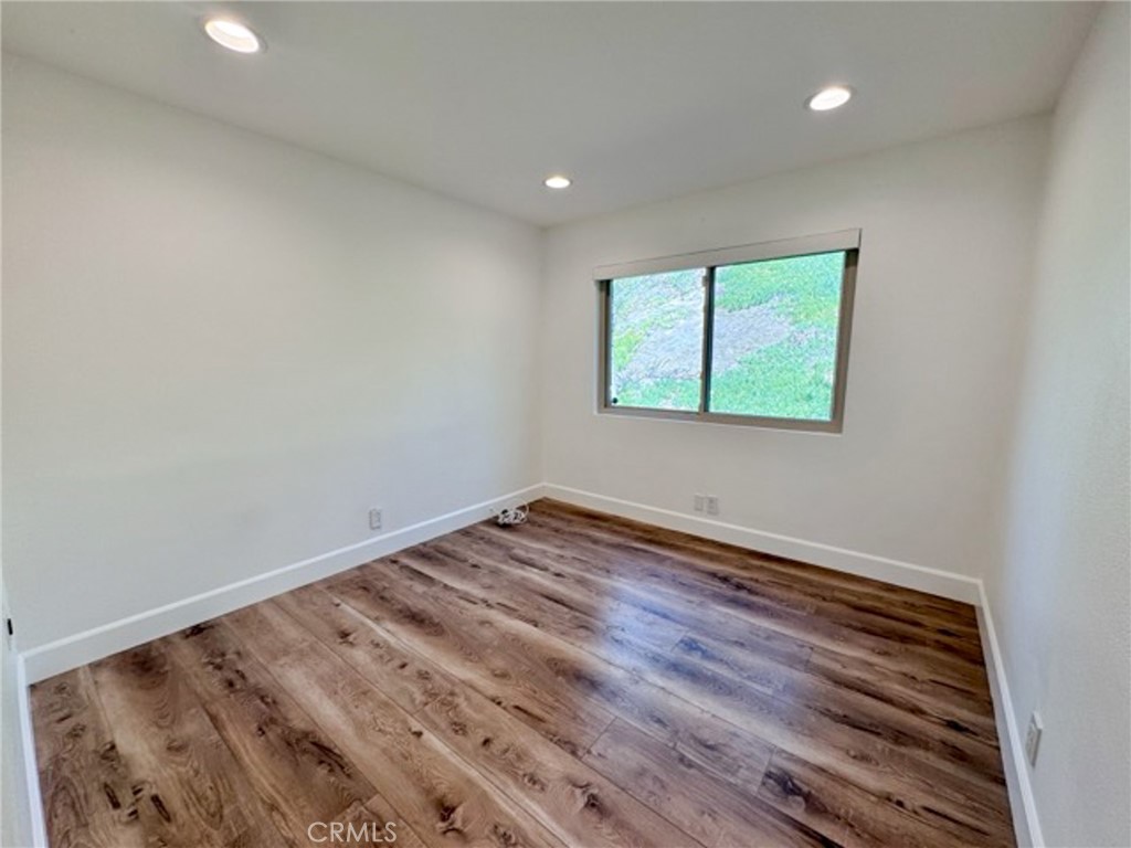 38901 Pso Corta Murrieta, CA 92563 - Photo 25 of 51 a view of an empty room with wooden floor and a window