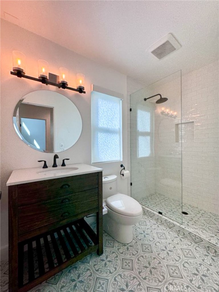 38901 Pso Corta Murrieta, CA 92563 - Photo 30 of 51 a bathroom with a sink toilet a mirror and shower