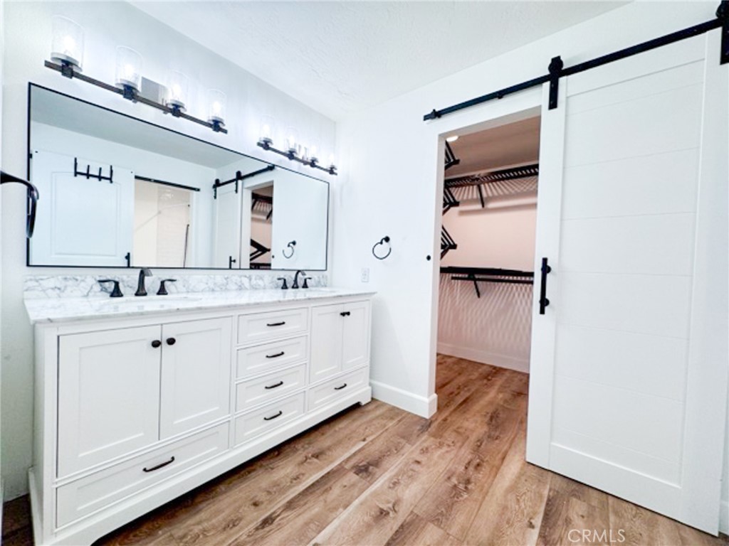 38901 Pso Corta Murrieta, CA 92563 - Photo 35 of 51 a spacious bathroom with a double vanity sink a mirror and shower