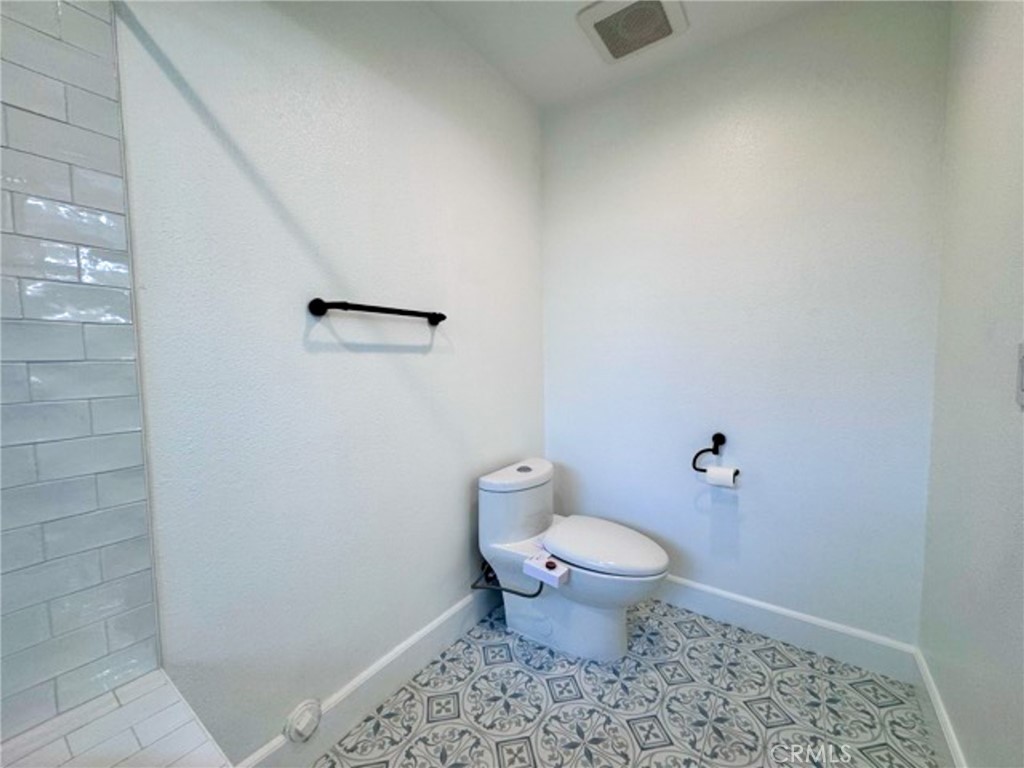38901 Pso Corta Murrieta, CA 92563 - Photo 38 of 51 a bathroom with a toilet and a shower