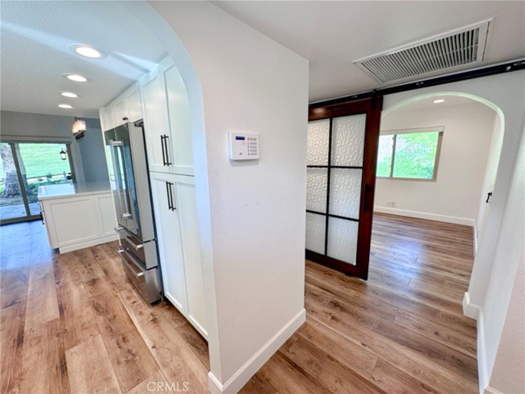 38901 Pso Corta Murrieta, CA 92563 - Photo 10 of 51 a view of a hallway with wooden floor and staircase