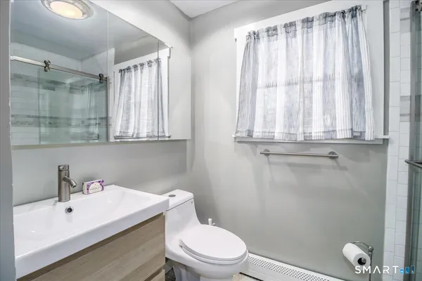 a white toilet sitting next to a bathroom sink