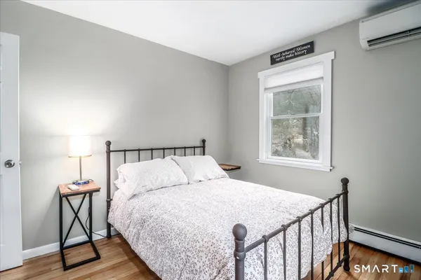 a bedroom with a bed a window and walk in closet