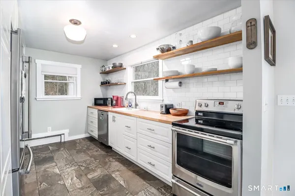 a kitchen with stainless steel appliances a stove and a refrigerator