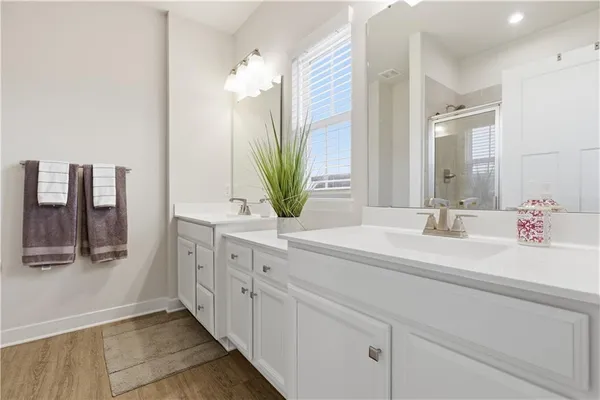 a bathroom with a double vanity sink and a mirror