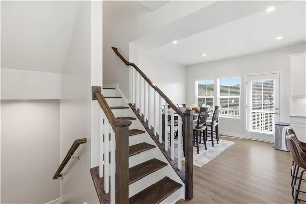 a view of entryway with wooden floor and stairs