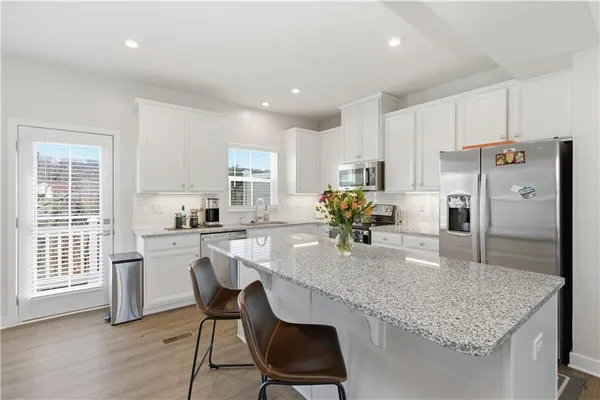 a bedroom with a bed next to a window and a dresser
