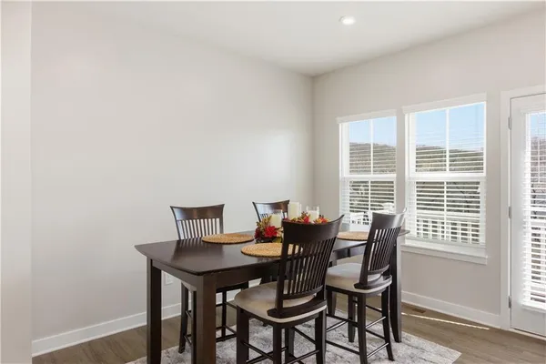 a view of a dining room with a table and chairs