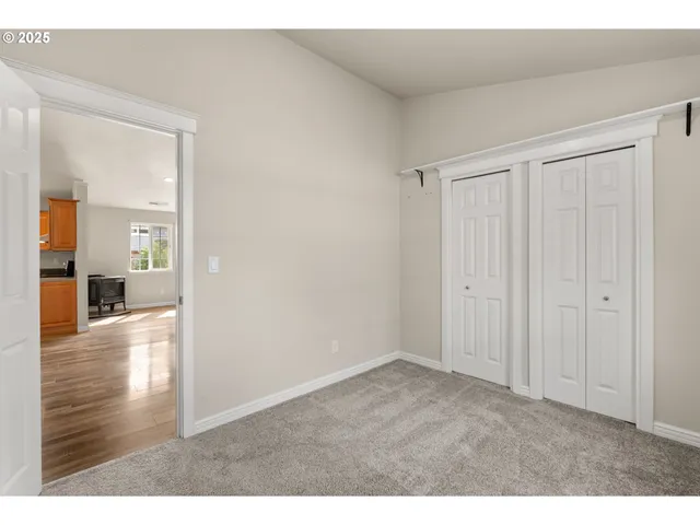 a big room with wooden floor a bathroom and a sink