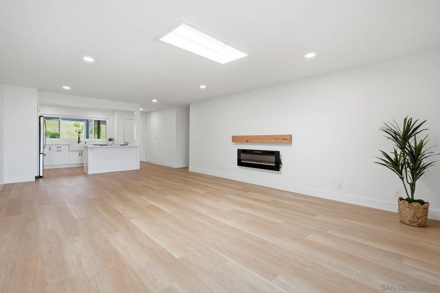 3606 Vista Rey, Unit 46 Oceanside, CA 92057 - Photo 11 of 36 a view of an empty room with a window and wooden floor