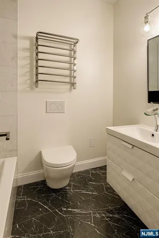 a bathroom with a sink toilet and mirror