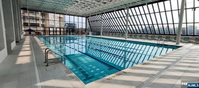 an outdoor space with swimming pool and furniture