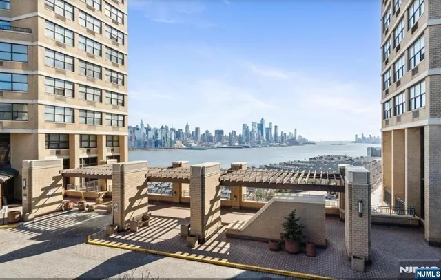 a view of roof deck with two chairs and a dining table