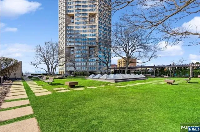 a view of a swimming pool with a bench and trees