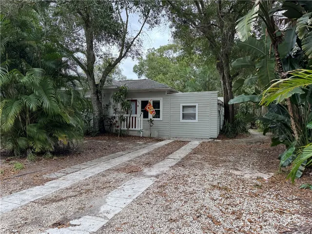 a view of a house with a yard and tree