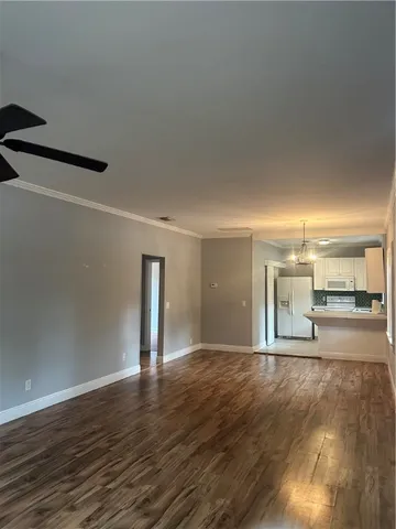 a view of a room with wooden floor